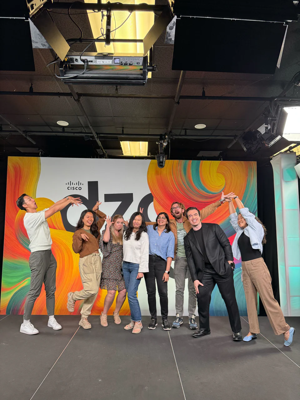 A Cisco design team posing together on stage.