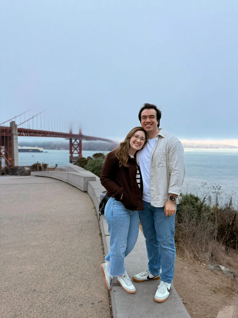 Francis and his partner in front of the Golden Gate Bridge.