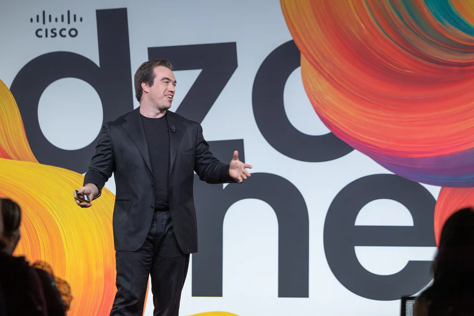 Francis speaking on a Cisco design stage.