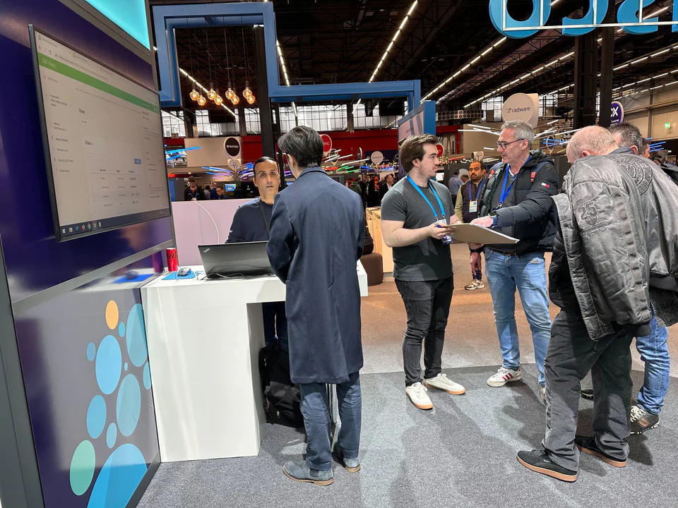 Francis sketching with customers at a product demo booth.
