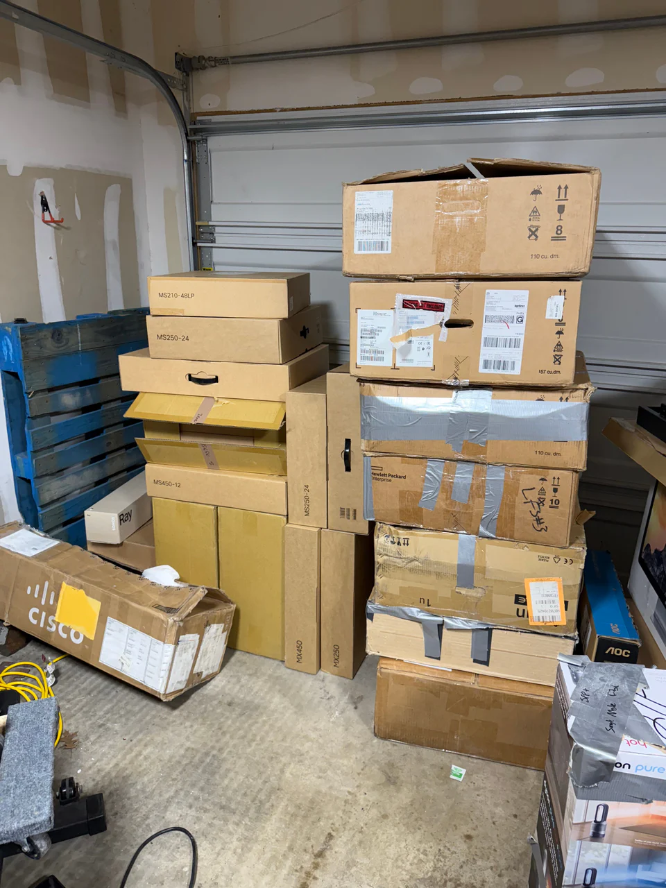Meraki and server hardware boxes stacked during a move.